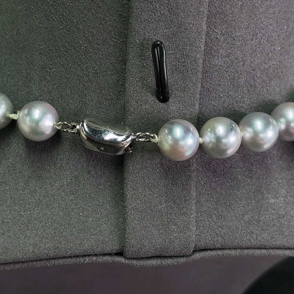Saltwater pearl strand necklace by HKHQ featuring elegant white pearls on a non-gold setting, displayed on a neutral background.