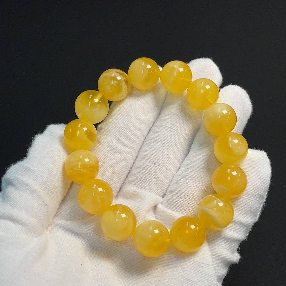 Huiliu Amber Beeswax Beads Bracelet featuring 13.7mm amber beads, natural and polished for a stylish, handcrafted jewelry piece.