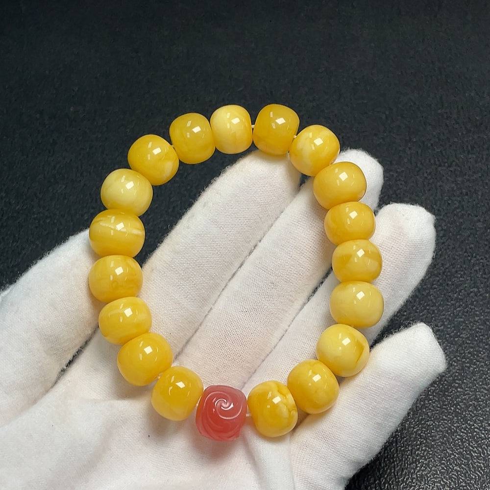 Huiliu Amber Beeswax Bracelet with Southern Red Agate beads, natural amber jewelry featuring warm hues and intricate bead details.