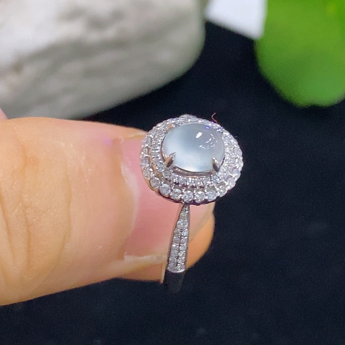Jadeite cabochon solitaire ring with 18K gold band and diamond accents, elegant jewelry piece showcasing a polished jadeite gemstone.