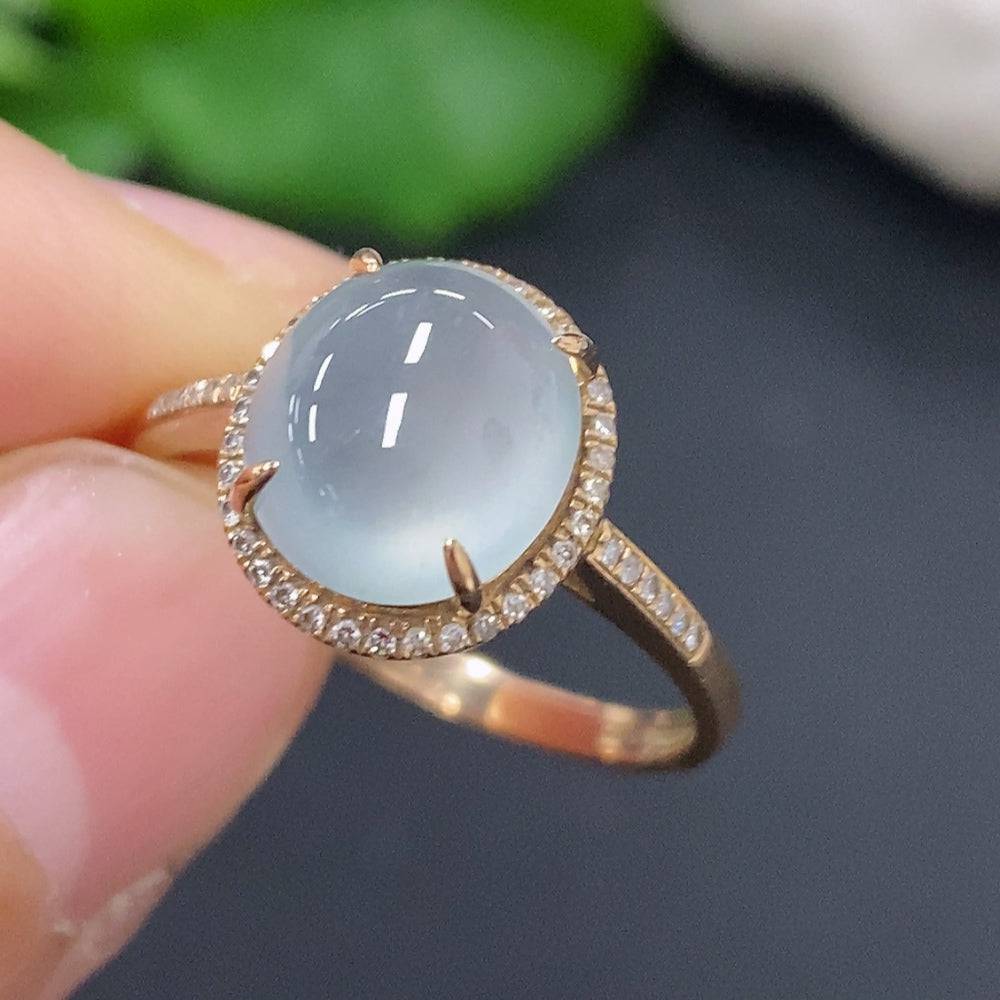 Huiliu Jadeite cabochon ring with diamond accents, featuring a polished green jade gemstone in a elegant jewelry setting.