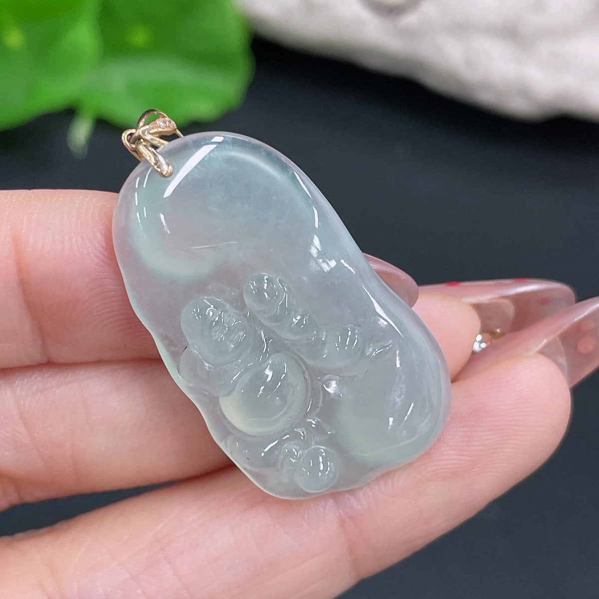 Huiliu Jadeite Buddha pendant with bezel, featuring a detailed carved Buddha figure on smooth green jade gemstone.