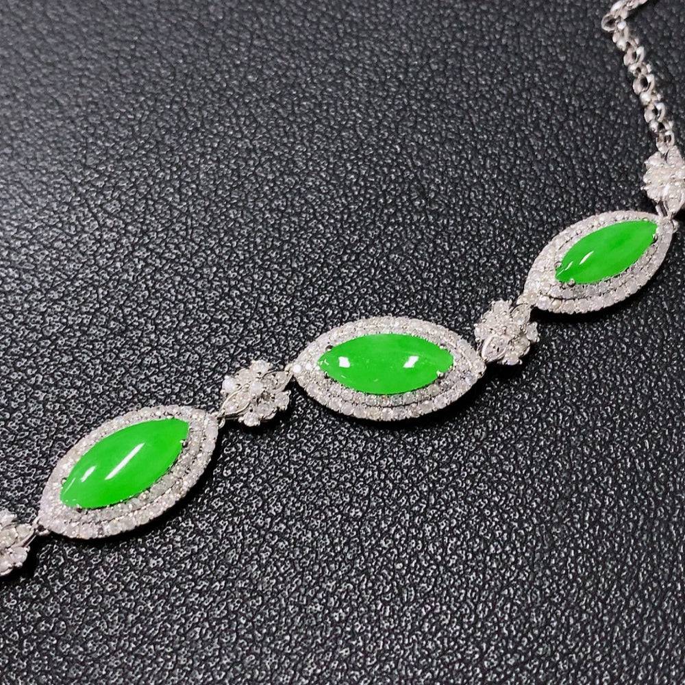 Jadeite jewelry set with necklace, bracelet, earrings, and ring featuring inlaid jade, 18k gold, and diamond accents.