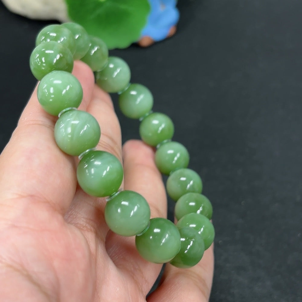 Green Hetian Jade bracelet from HKHQ featuring smooth, polished jade beads on a delicate string.