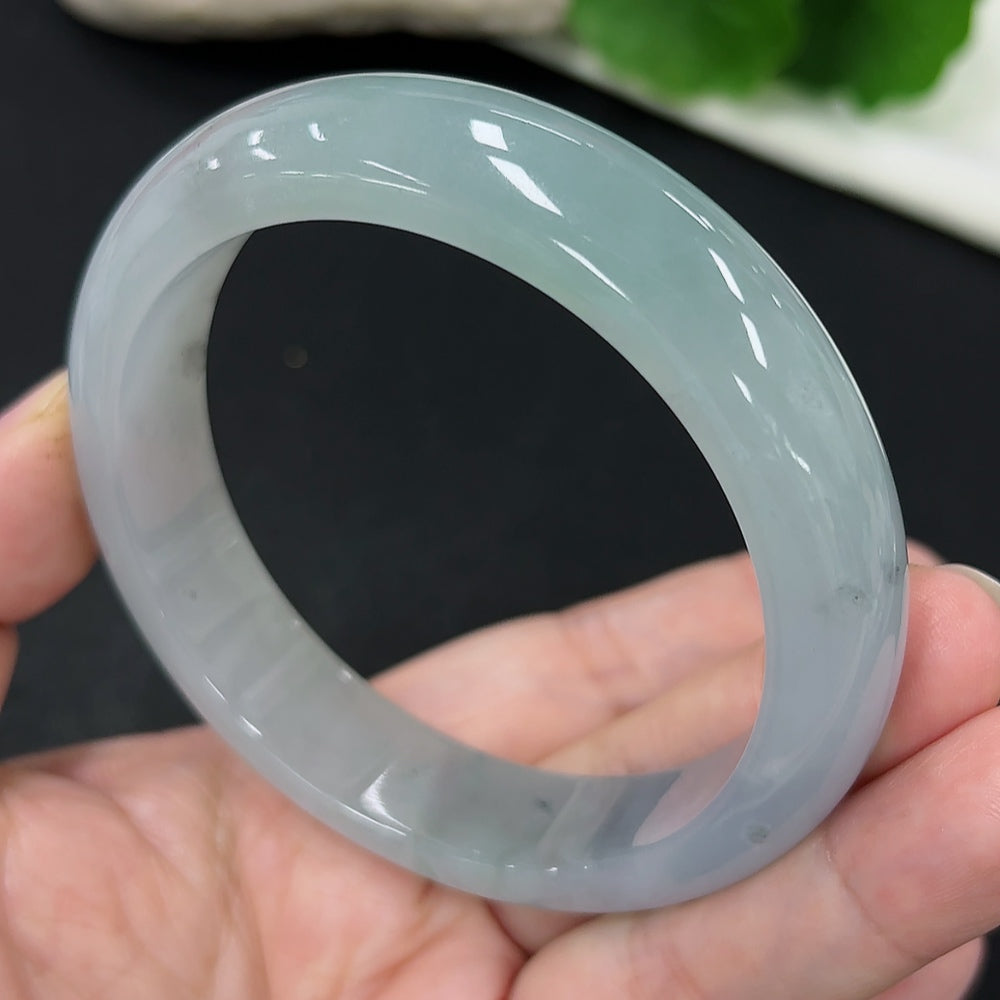 Jadeite round bangle by HKHQ, size 59.1, with a total weight of approximately 65.8 grams, showcasing smooth, polished jade surface.