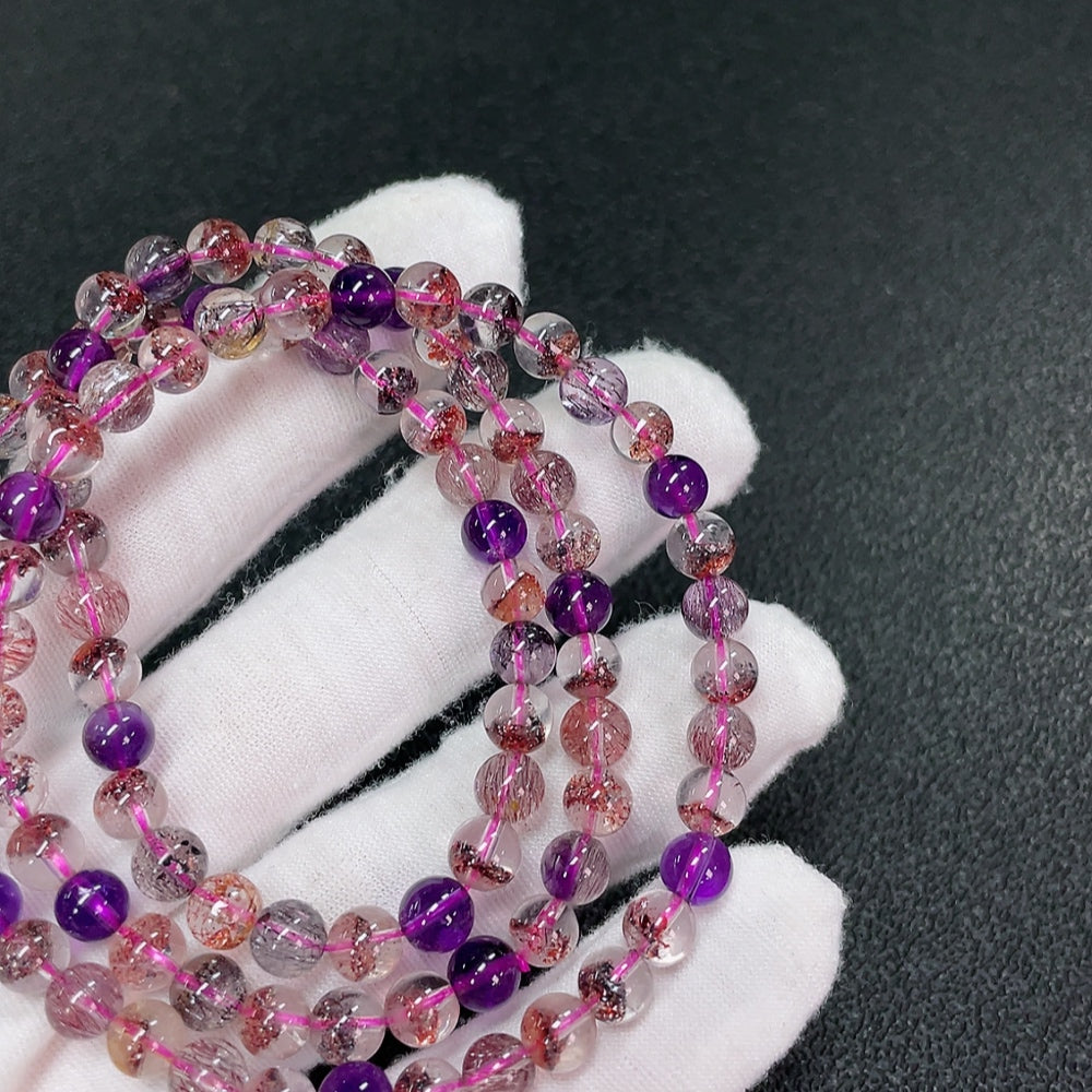 Huiliu Certified gemstone crystal bead strand, about 6.1mm, featuring clear, polished gemstone beads arranged in a continuous strand.