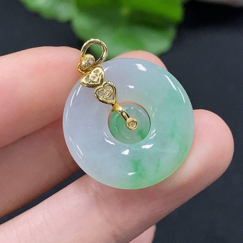 Jadeite mother-and-son pendant with 18K gold accents and diamond details, showcasing intricate inlaid jade design.