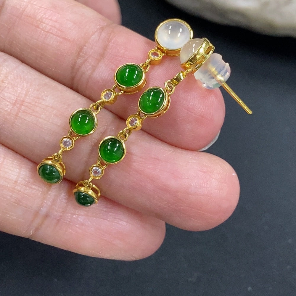 Jadeite cabochon earrings in 18K gold with a smooth, rounded design, featuring non-diamond gemstone accents.
