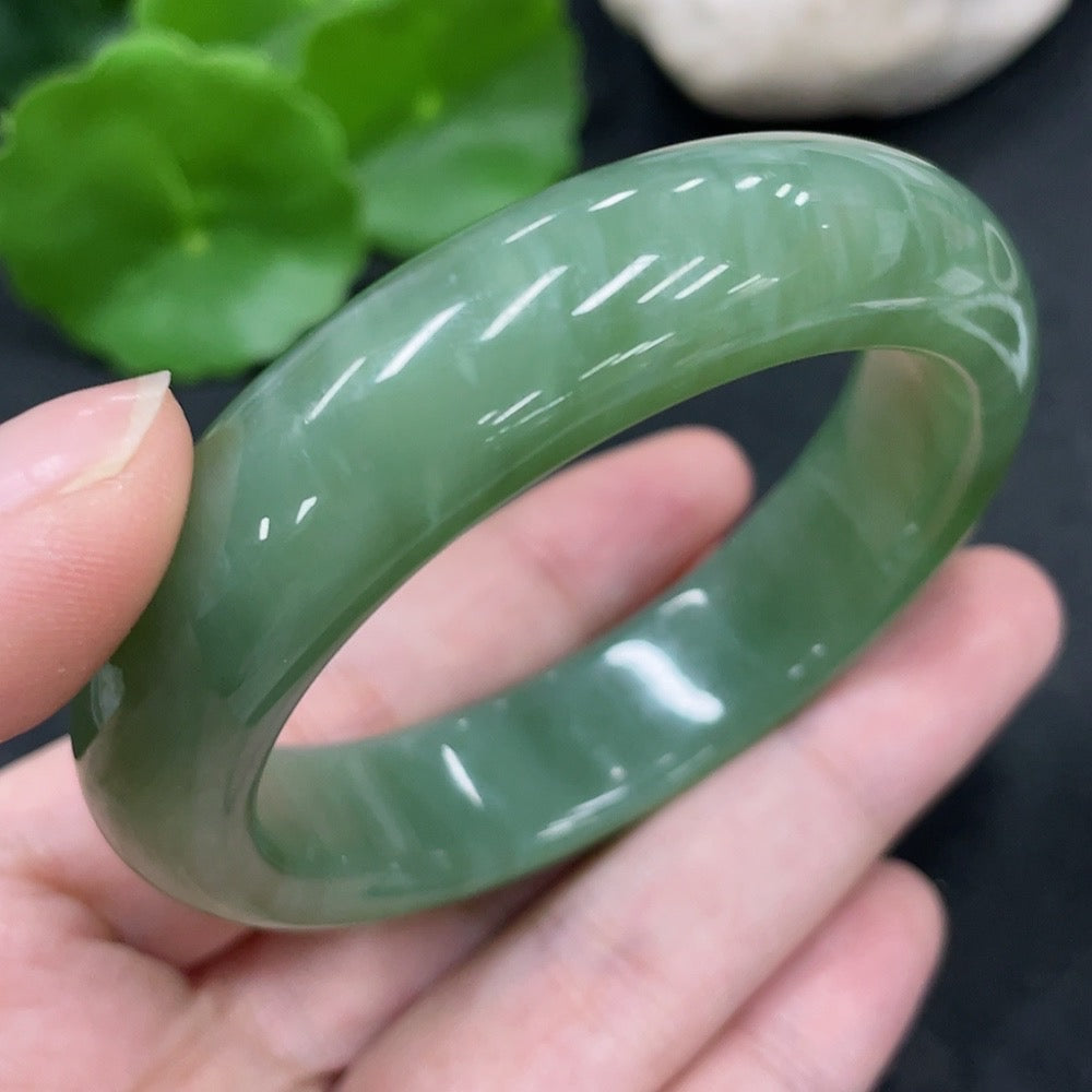 Huiliu certified Hetian jade round bracelet with smooth, polished jade beads showcasing natural green hues and intricate craftsmanship.