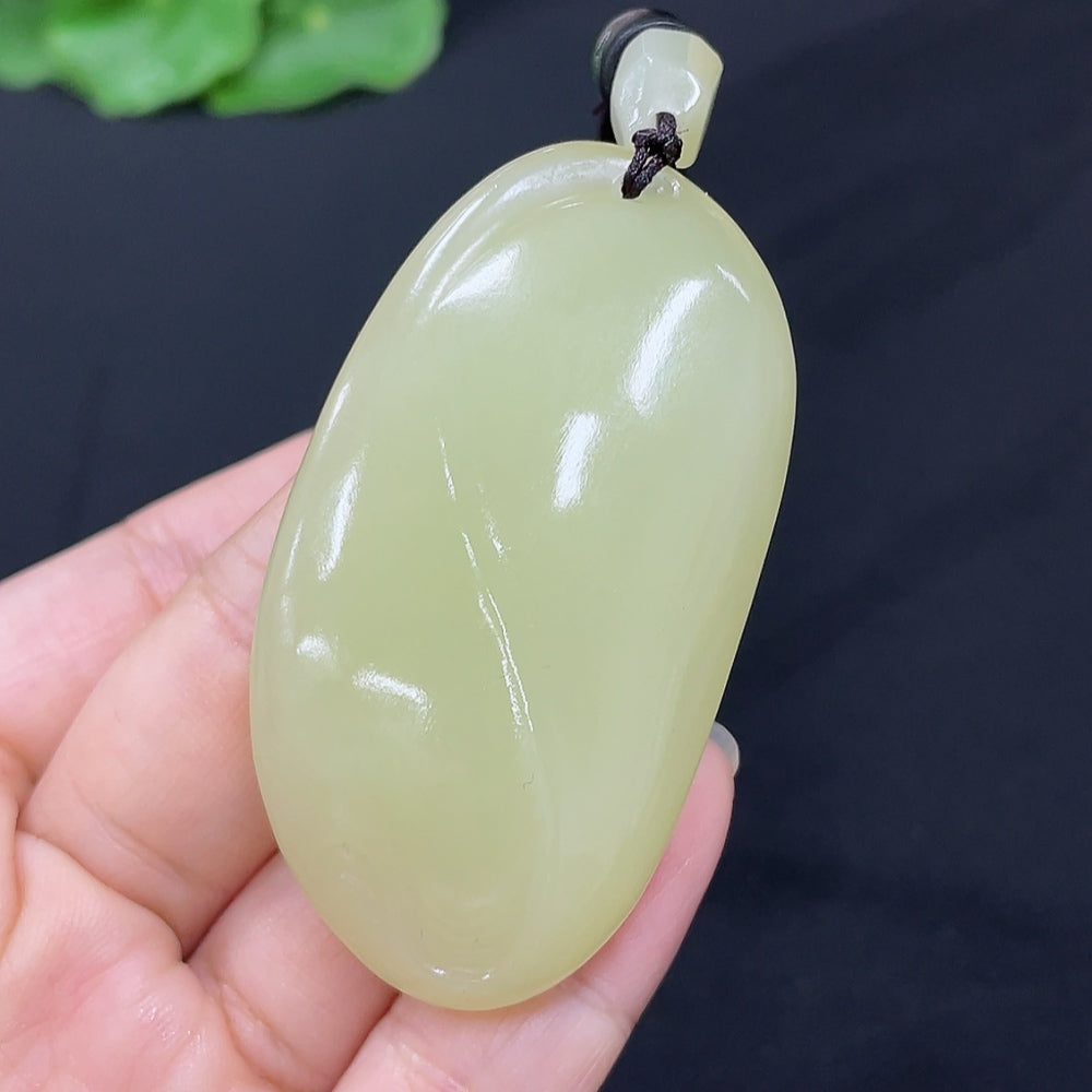 Hetian Jade freeform pendant necklace by HKHQ featuring a smooth, polished jade stone with natural variations on a delicate chain.
