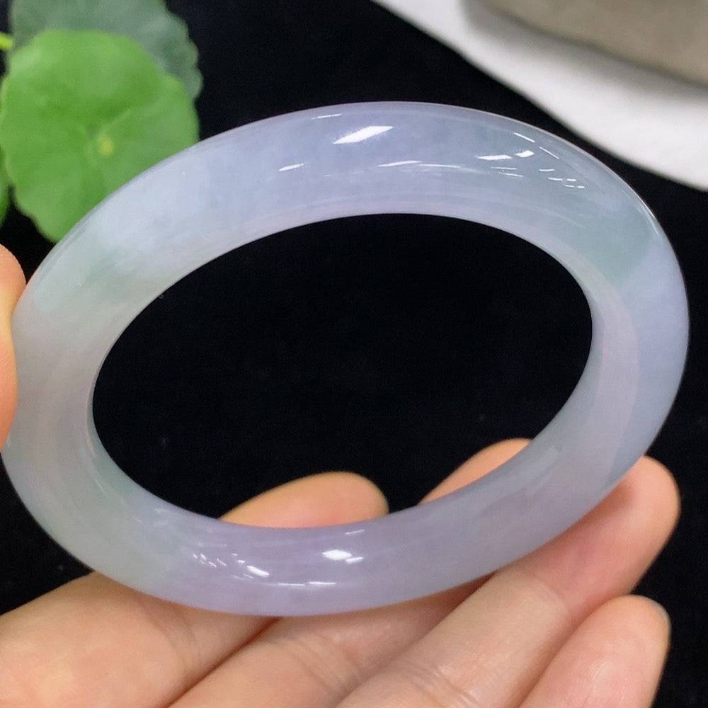Huiliu Certified Jadeite round bangle featuring smooth, polished green jade with natural stone patterns and a glossy finish.
