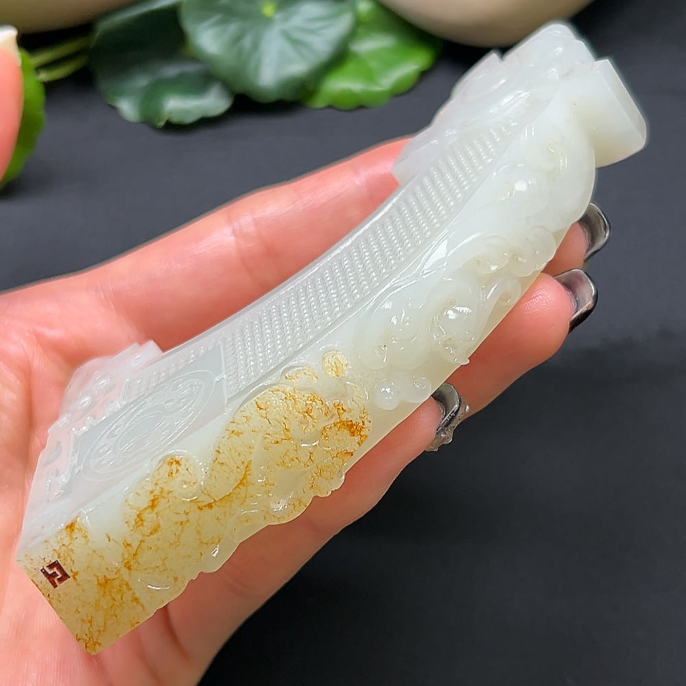Close-up of a Hetian Jade Chinese Dream Ornament, crafted from smooth green jade with intricate carved details.