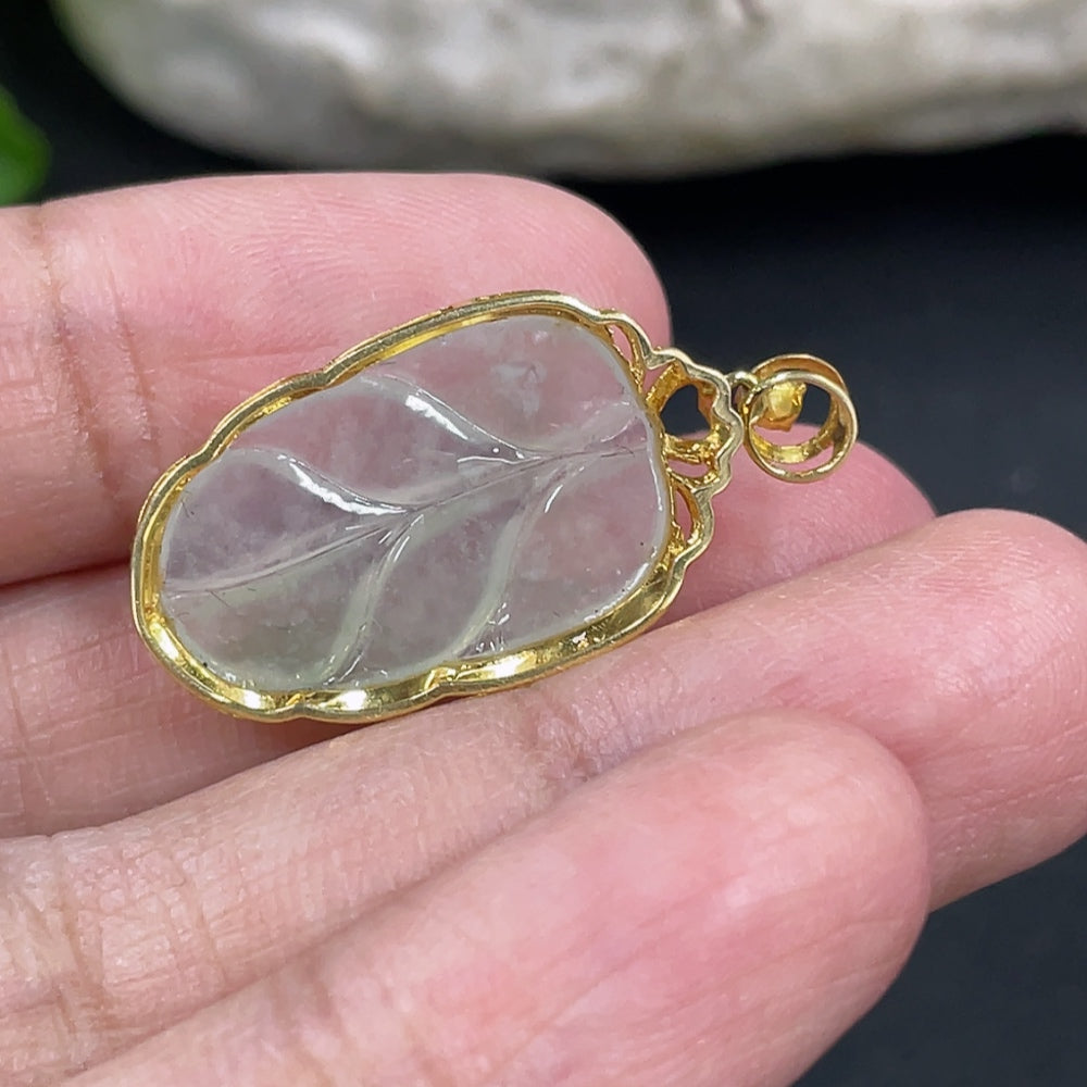 Jadeite leaf pendant with 18k gold and diamond inlays, crafted by HKHQ, featuring intricate jade and gold detailing.