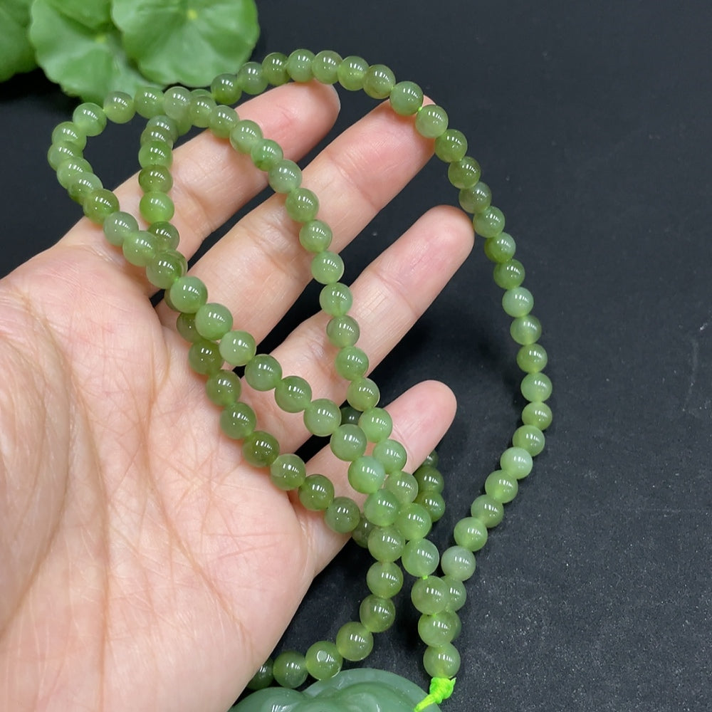 Huiliu Certified Hetian Jade Buddha pendant with chain, featuring a smooth carved jade Buddha figure on a delicate chain.