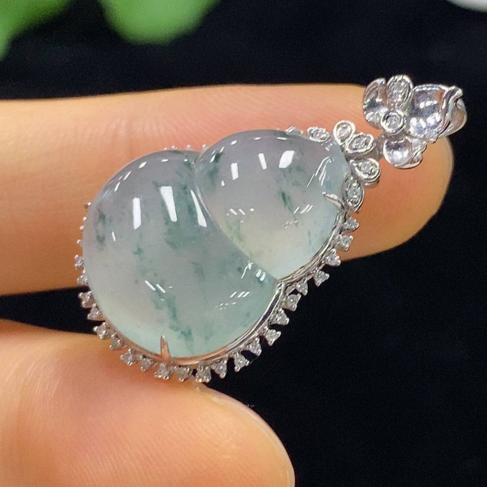 Jadeite gourd pendant with 18K gold accents and diamond inlays, showcasing intricate craftsmanship and luminous green jade.
