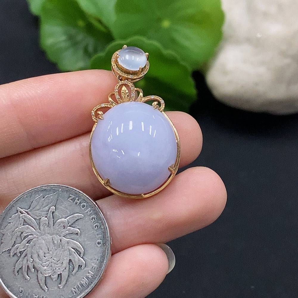 Jadeite cabochon pendant set in 18K gold with diamond accents, featuring a polished green jade gemstone and elegant gold design.