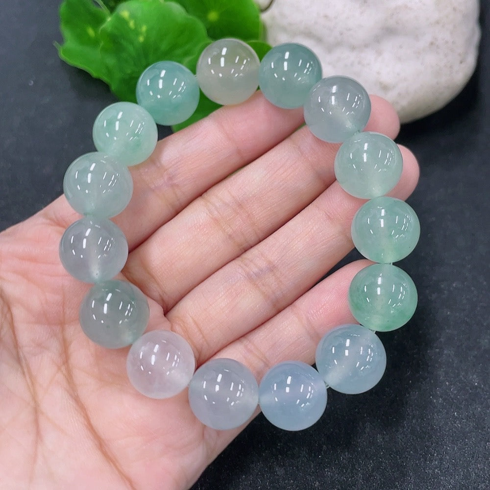 HKHQ jadeite bracelet with 13.4mm stones, weighing approximately 56.13g, showcasing smooth, polished jadeite beads.