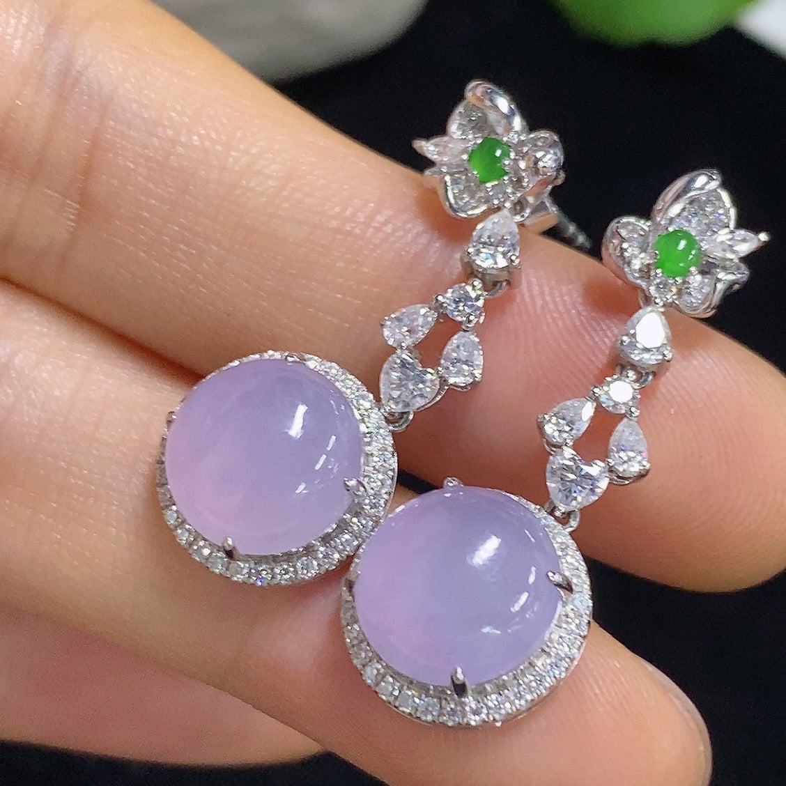 HKHQ jadeite cabochon earrings with 18K gold setting, showcasing smooth, polished green jade stones on elegant earring hooks