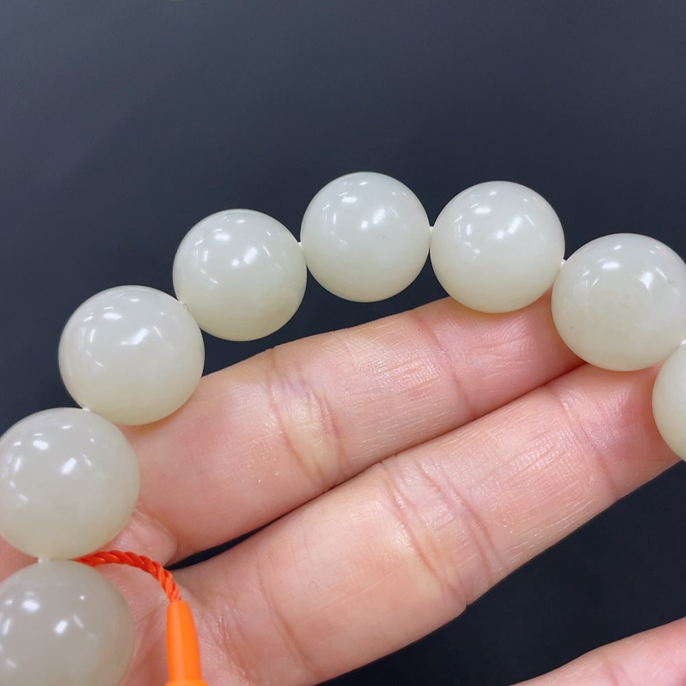 HKHQ Hetian Jade bracelet with 13.9mm beads and 64.2g weight, showcasing smooth, polished green jade stones.