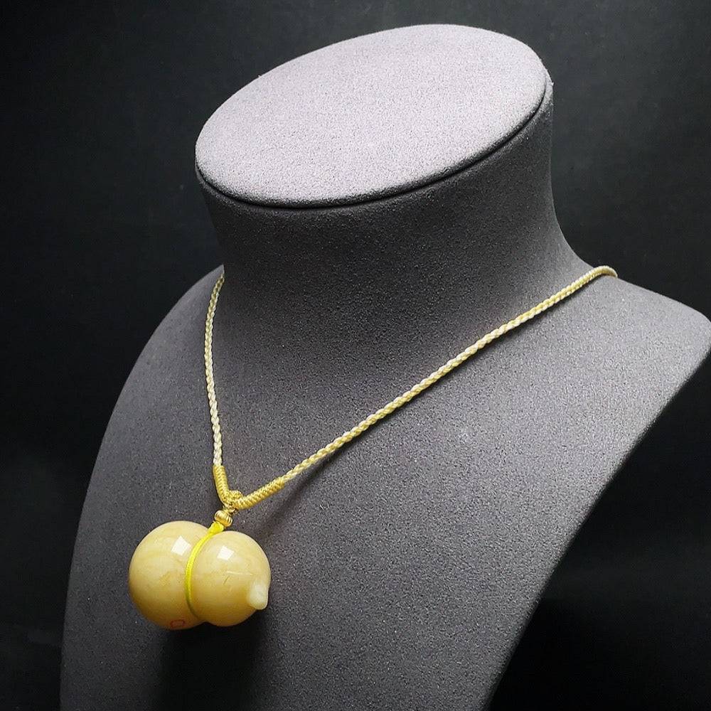 HUILIU HQ Amber beeswax pendant with visible repair marks, showcasing natural amber color and handcrafted design.