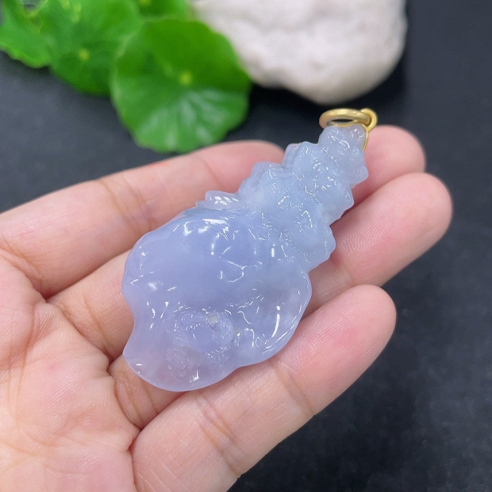 Jadeite inlaid pendant with 18k gold setting, weighing approximately 21.84g, featuring intricate jade craftsmanship.