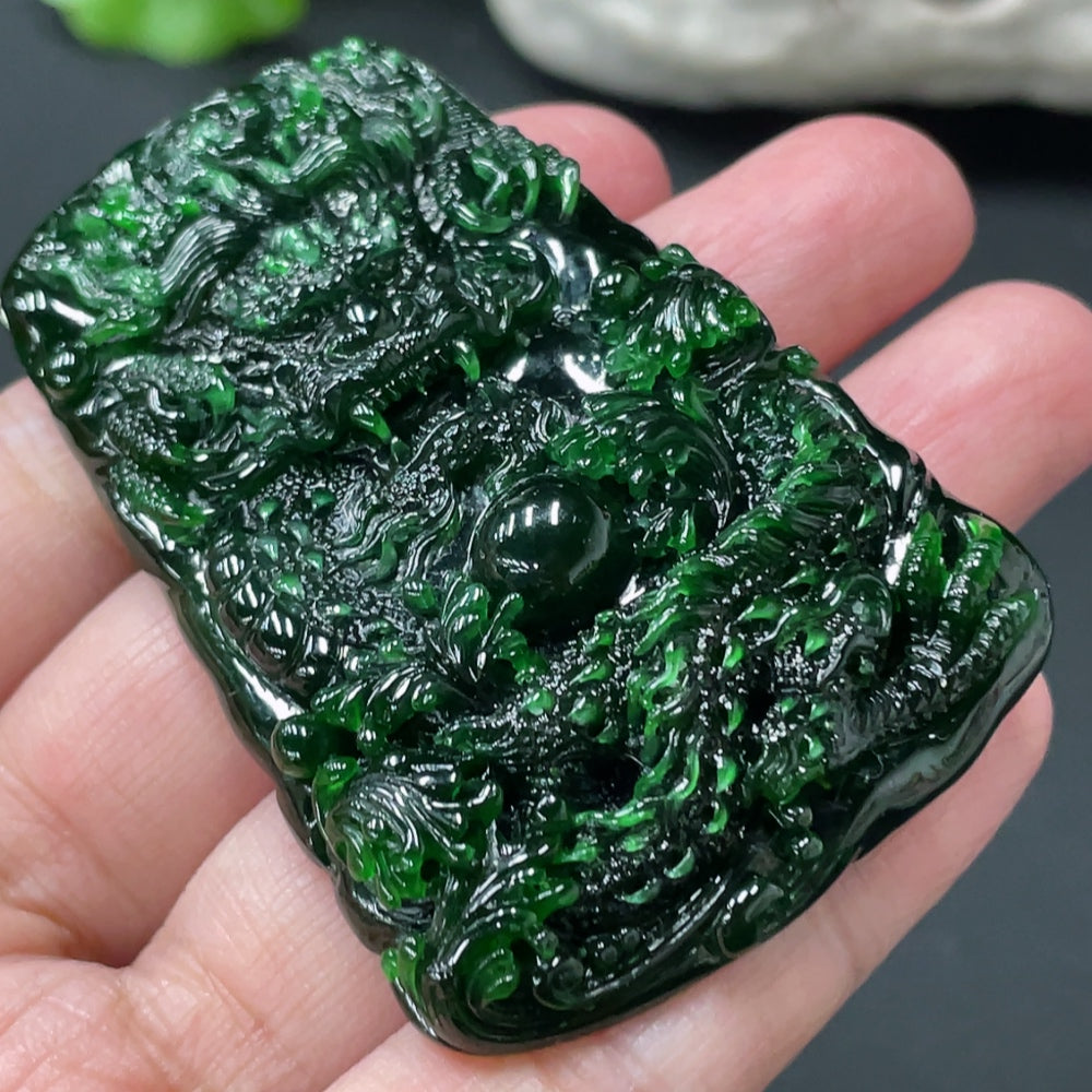 Jadeite dragon pendant from HUILIU HQ with intricate dragon design, weighing approximately 40g, showcasing smooth green jade stone.