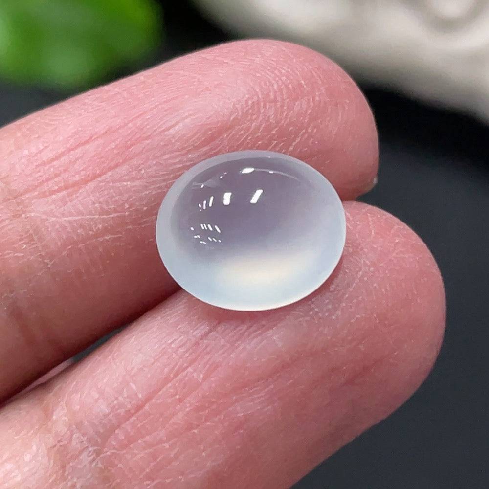 Jadeite cabochon gemstone from HUILIU HQ, approx. 0.73g, smooth polished jade stone with vibrant green color.