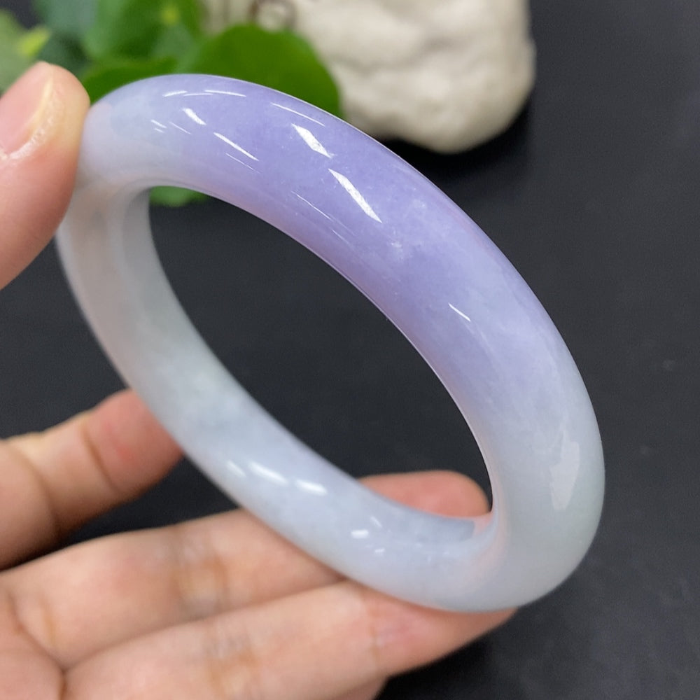 HKHQ jadeite round bangle in size 56.3, weighing 77.3g, showcasing smooth, polished green jadeite bracelet on a neutral background.