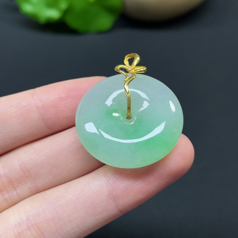 Jadeite Peace Knot pendant with 18k gold, diamond side stones, detailed inlaid design, weight approximately 10.92g.