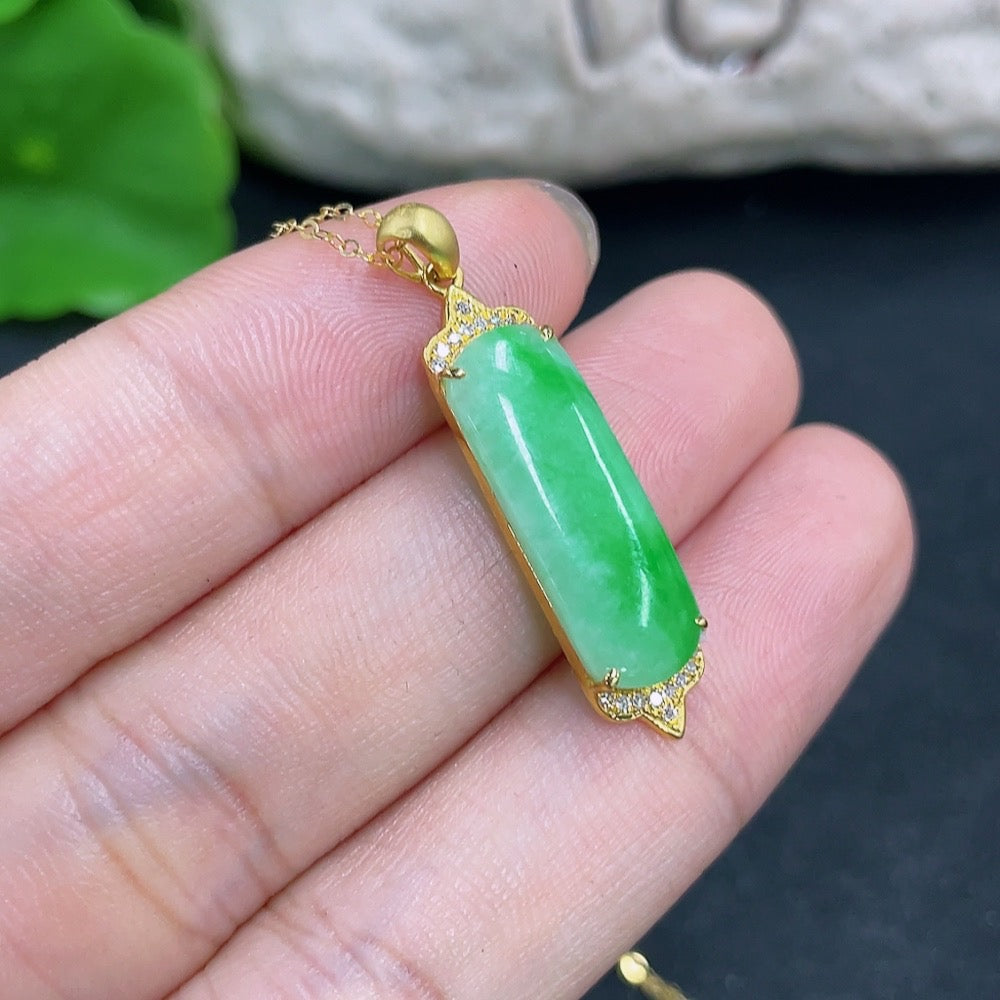 Jadeite pendant with 18K gold and diamond accents, elegant necklace featuring a polished green jadeite stone.
