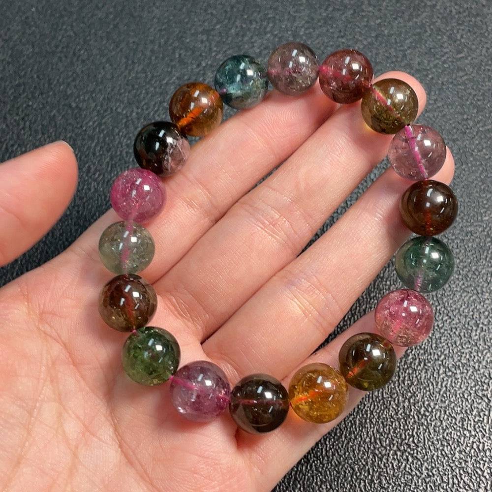 Huiliu certified tourmaline gemstone bracelet with 11.7mm size, featuring visible organic matter and natural gemstone details.