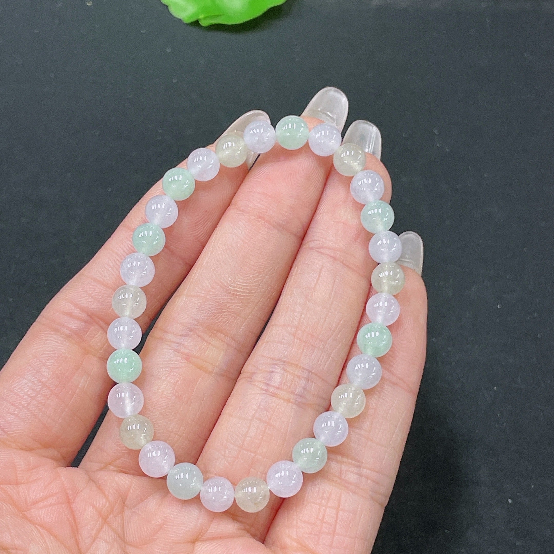 HUILIU HQ jadeite bracelet with 5.6mm beads, weighing approximately 10.12 grams, showcasing smooth, polished jade stones.