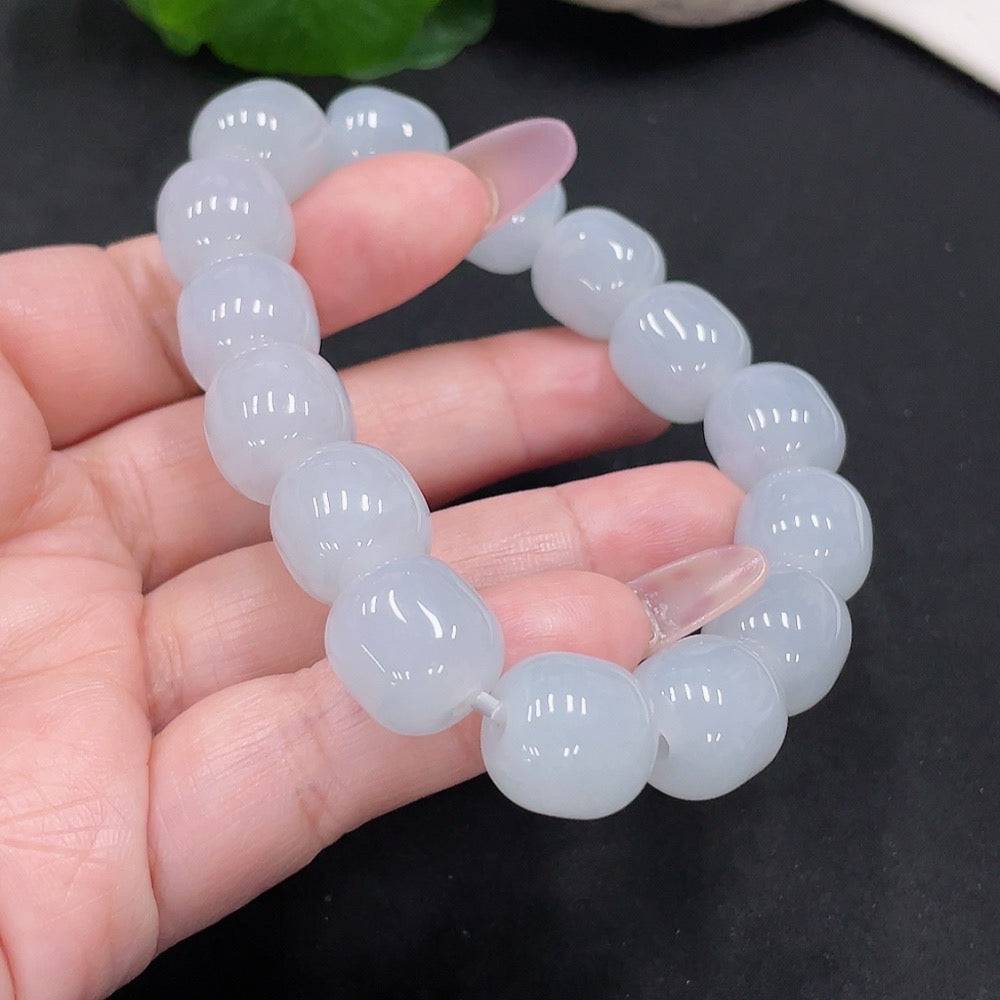 Huiliu Jadeite bracelet with 12.8mm beads, featuring polished green jade stones on a string, showcasing natural luster and craftsmanship.