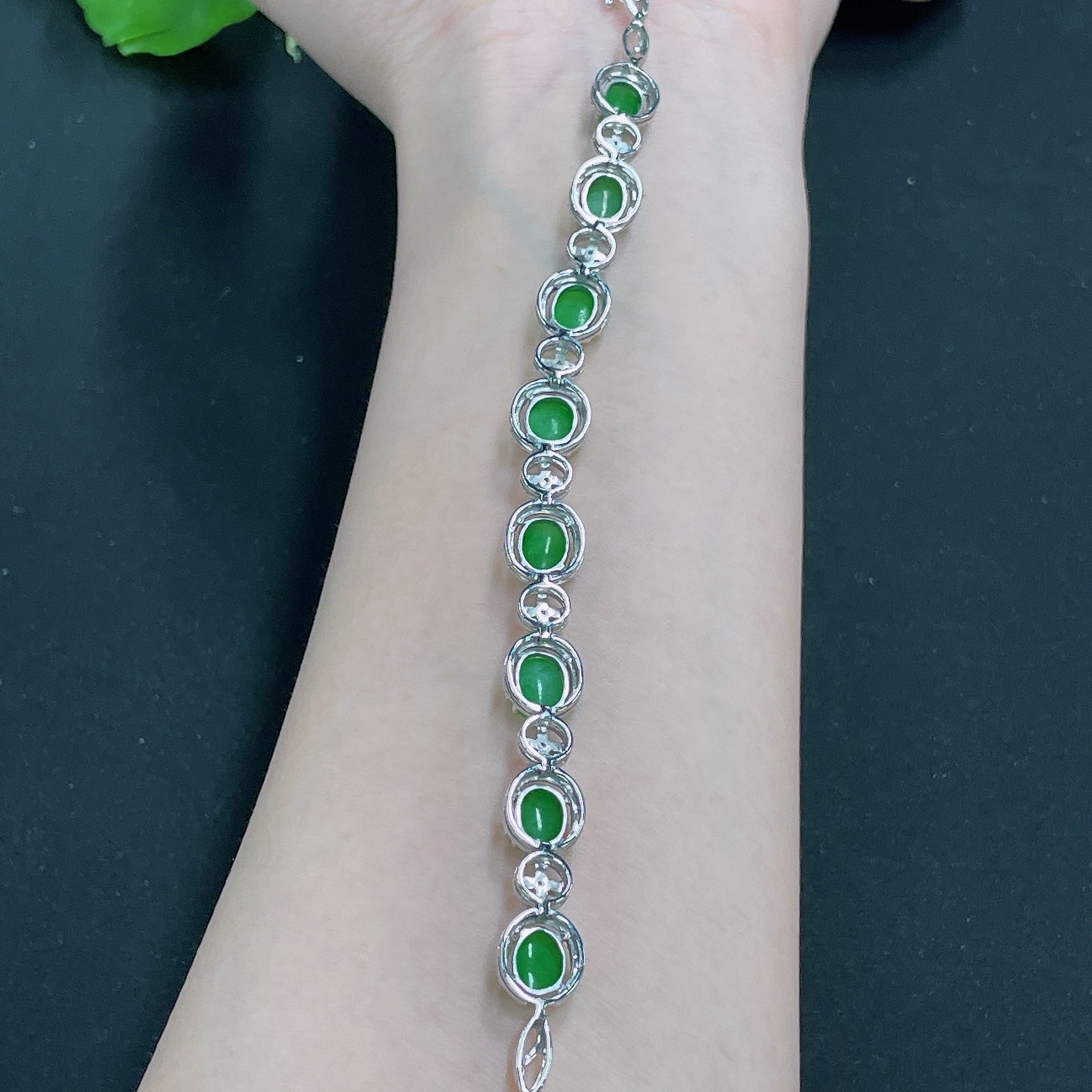 Huiliu jadeite bracelet inlaid with diamonds, featuring a polished green jade design with sparkling diamond accents.