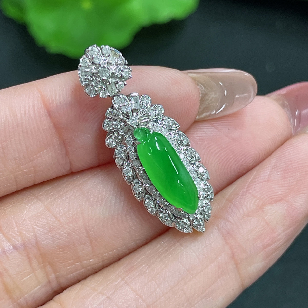 Jadeite melon drop pendant by HKHQ featuring 18K gold and diamond accents, showcasing a polished jade pendant with gold and diamond details.