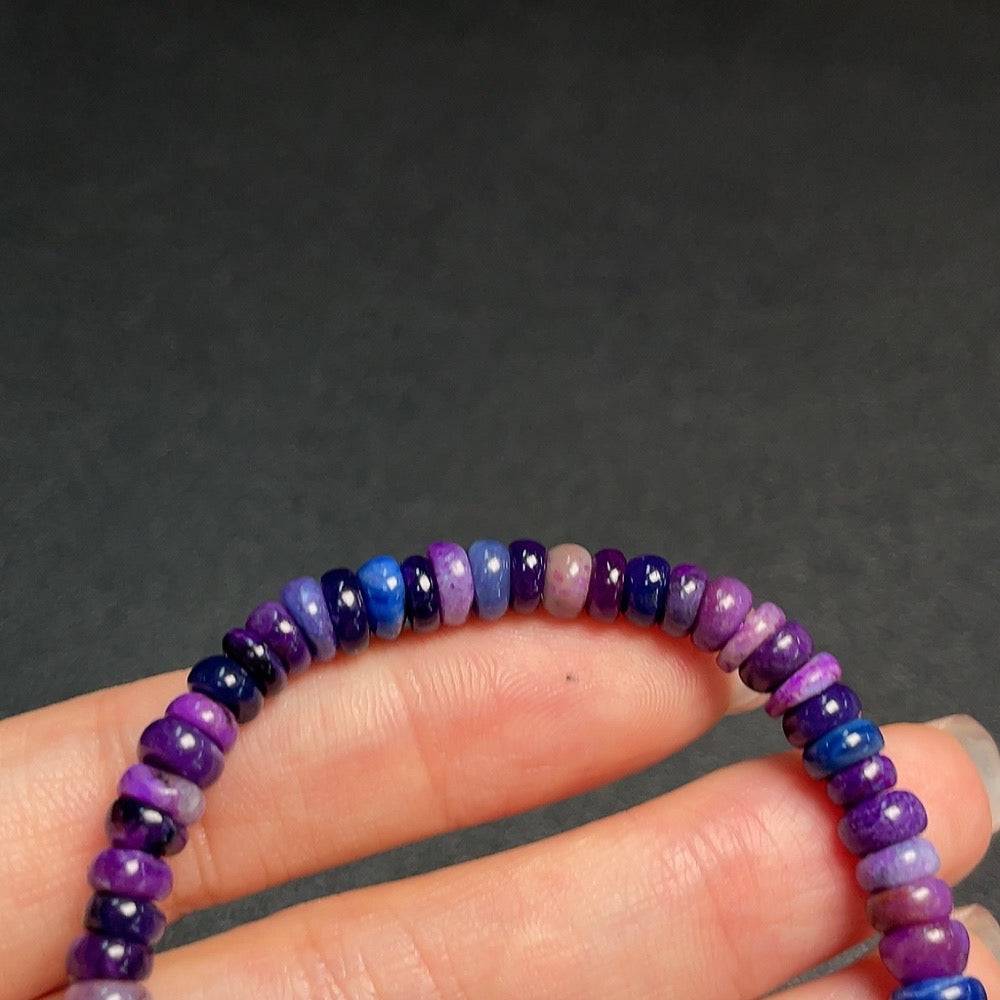 Purple Sugilite gemstone bracelet with 5.7mm beads, featuring mineral components and organic matter, from HUILIU HQ.