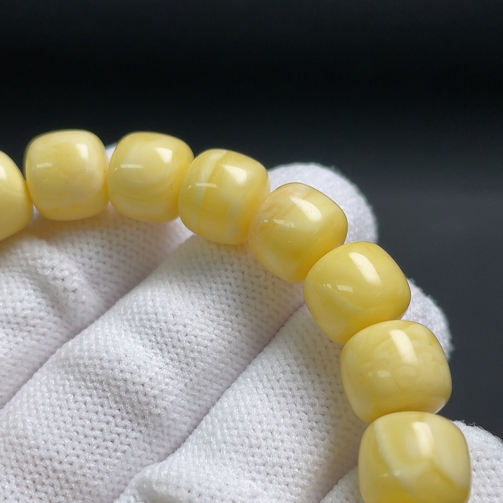 Amber beeswax bracelet with partial repairs, possibly turquoise accents, featuring 10.4mm beads, weighing around 14.1g, by HUILIU HQ.