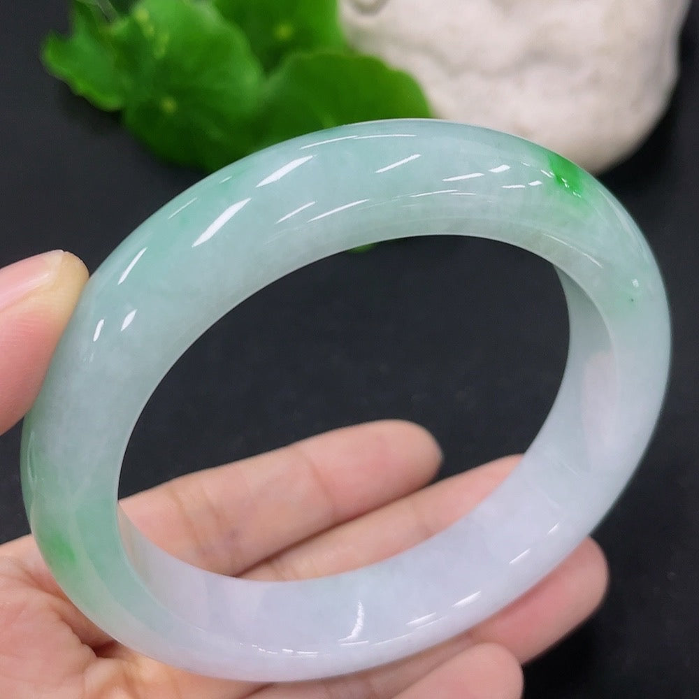 HKHQ jadeite round bangle in size 56, weighing 62.44g, showcasing smooth, polished green jadeite bracelet on a neutral background