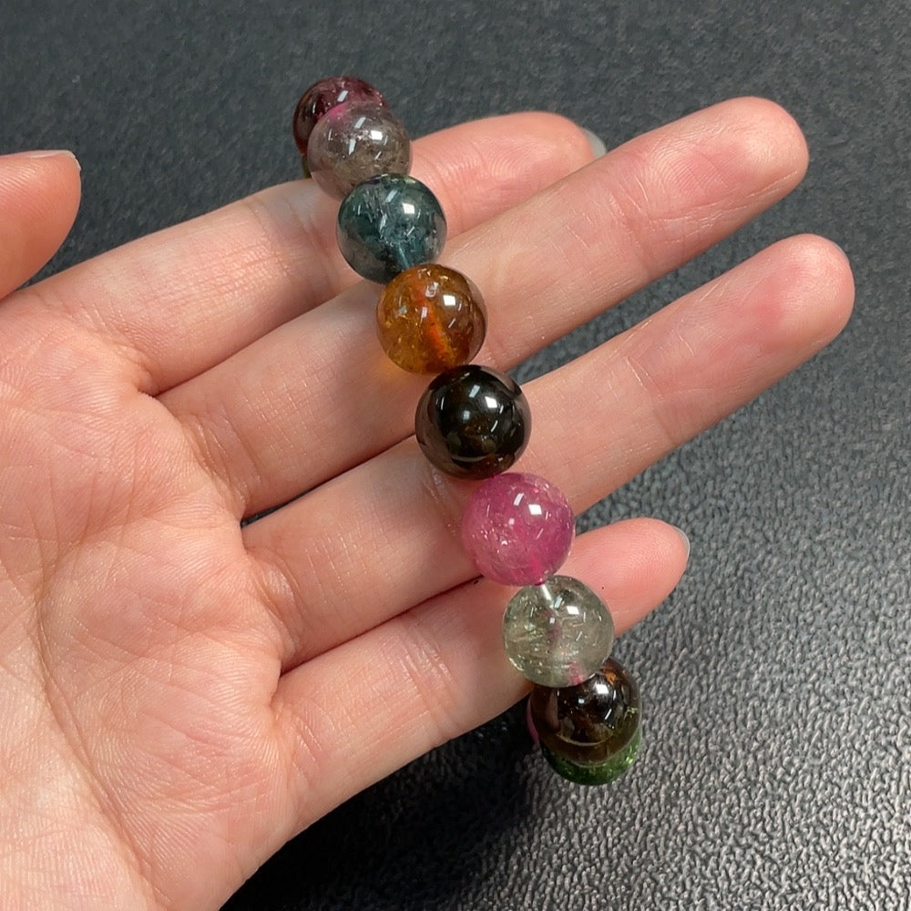 Huiliu certified tourmaline gemstone bracelet with visible organic matter, approximately 11.7mm size, showcasing natural gemstone details.
