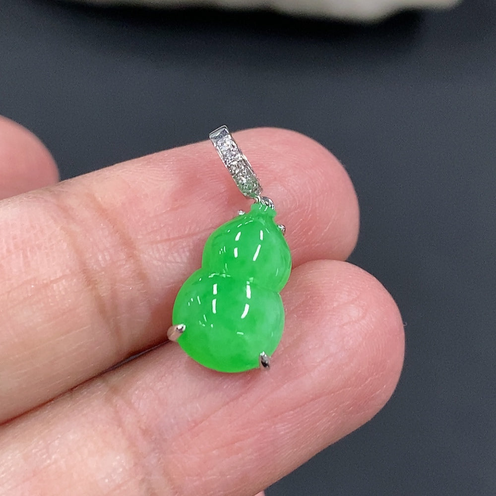 Jadeite gourd pendant with 18K gold and diamond accents, featuring intricate inlay work, displayed against a neutral background.