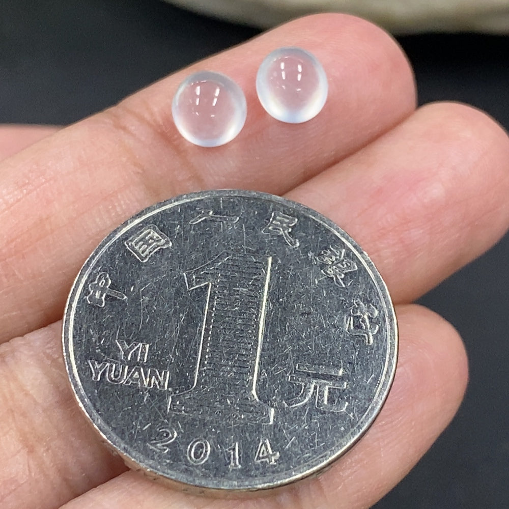 Close-up of a 0.49g jadeite cabochon jewelry piece featuring smooth, polished green gemstone with subtle natural variations.