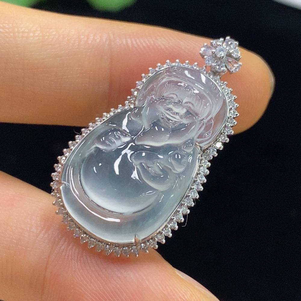 Jadeite Maitreya pendant with inlaid diamonds, 18k gold, displayed on a stand, showcasing intricate craftsmanship and luxurious design.