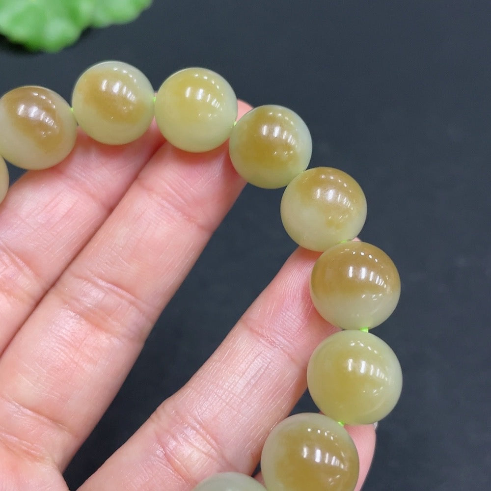 Hetian Jade bracelet with 11.9mm beads and a total weight of 41.7g, featuring smooth, polished green jade stones.