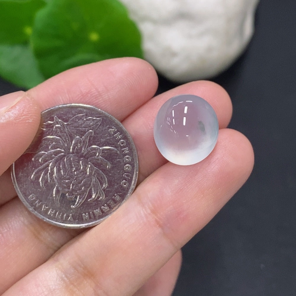 Jadeite cabochon jewelry piece from HKHQ, weighing 2.2g, showcasing a smooth, polished green gemstone on a jewelry setting.