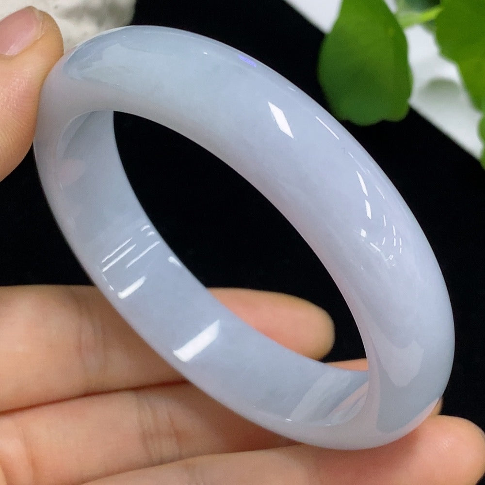 Jadeite round bangle in size 54.5, weighing approximately 52.66g, showcasing smooth green jade with polished finish.