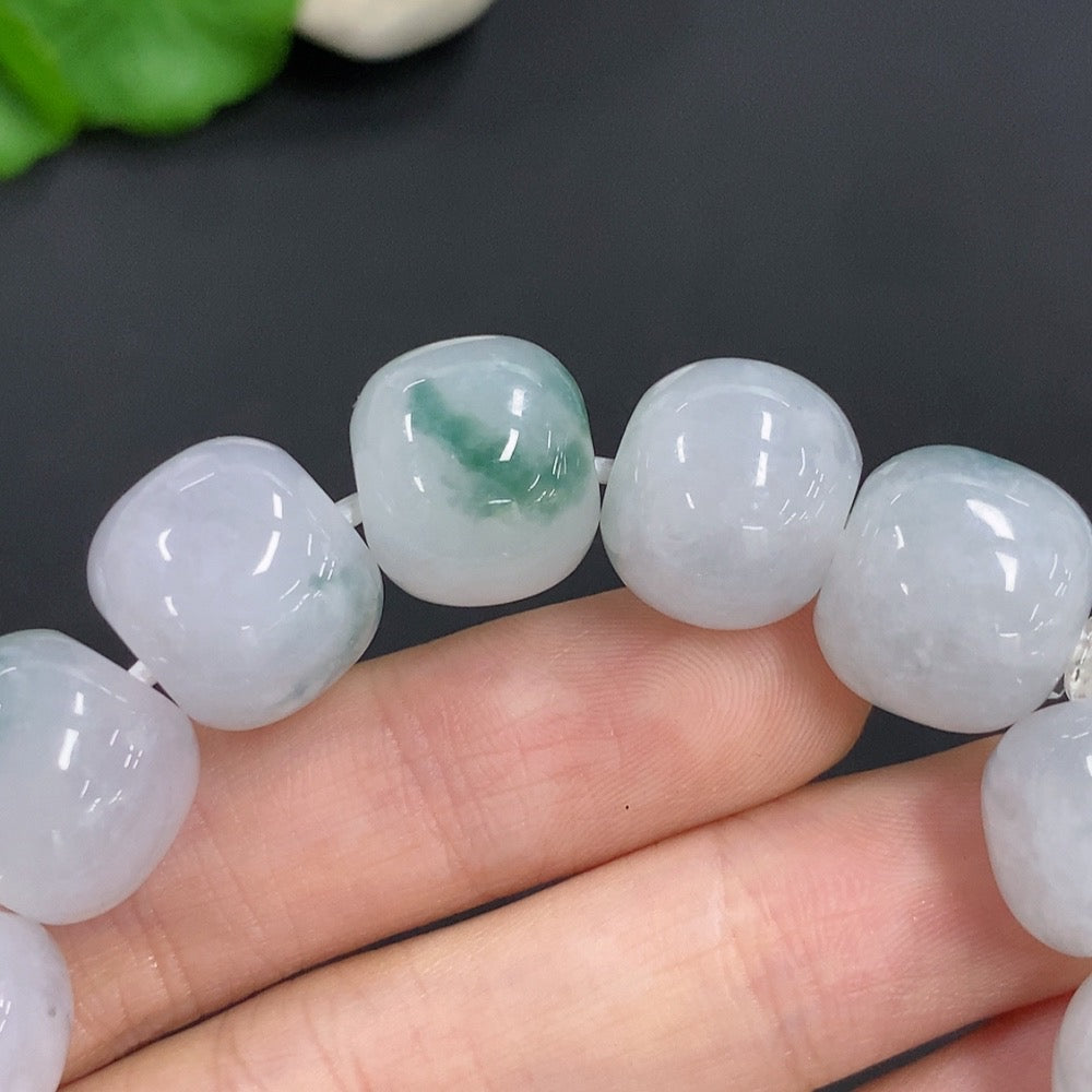 HKHQ jadeite bracelet weighing 83.3g featuring smooth, polished jadeite beads on a flexible string.