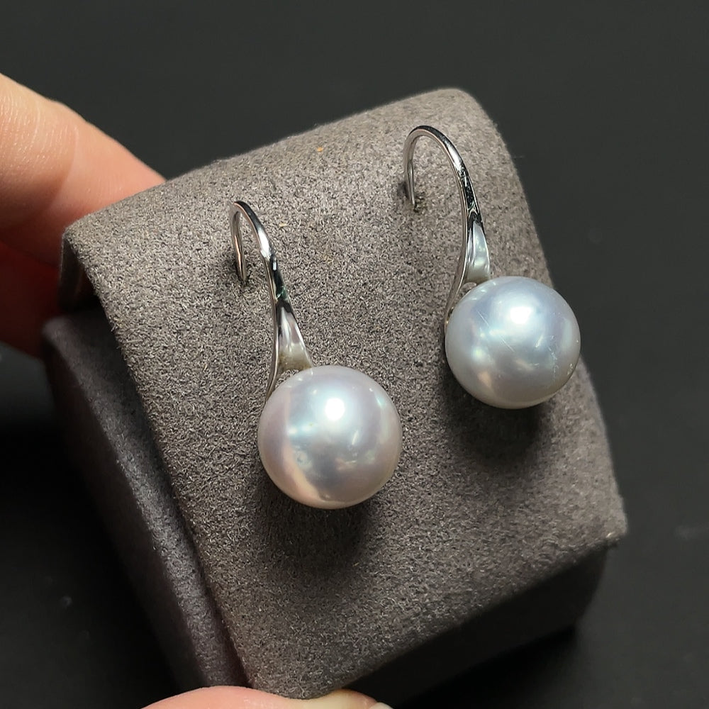 HKHQ seawater pearl earrings with 14k gold, 10.5mm pearls, total weight 4.3g, showcased in a close-up image.