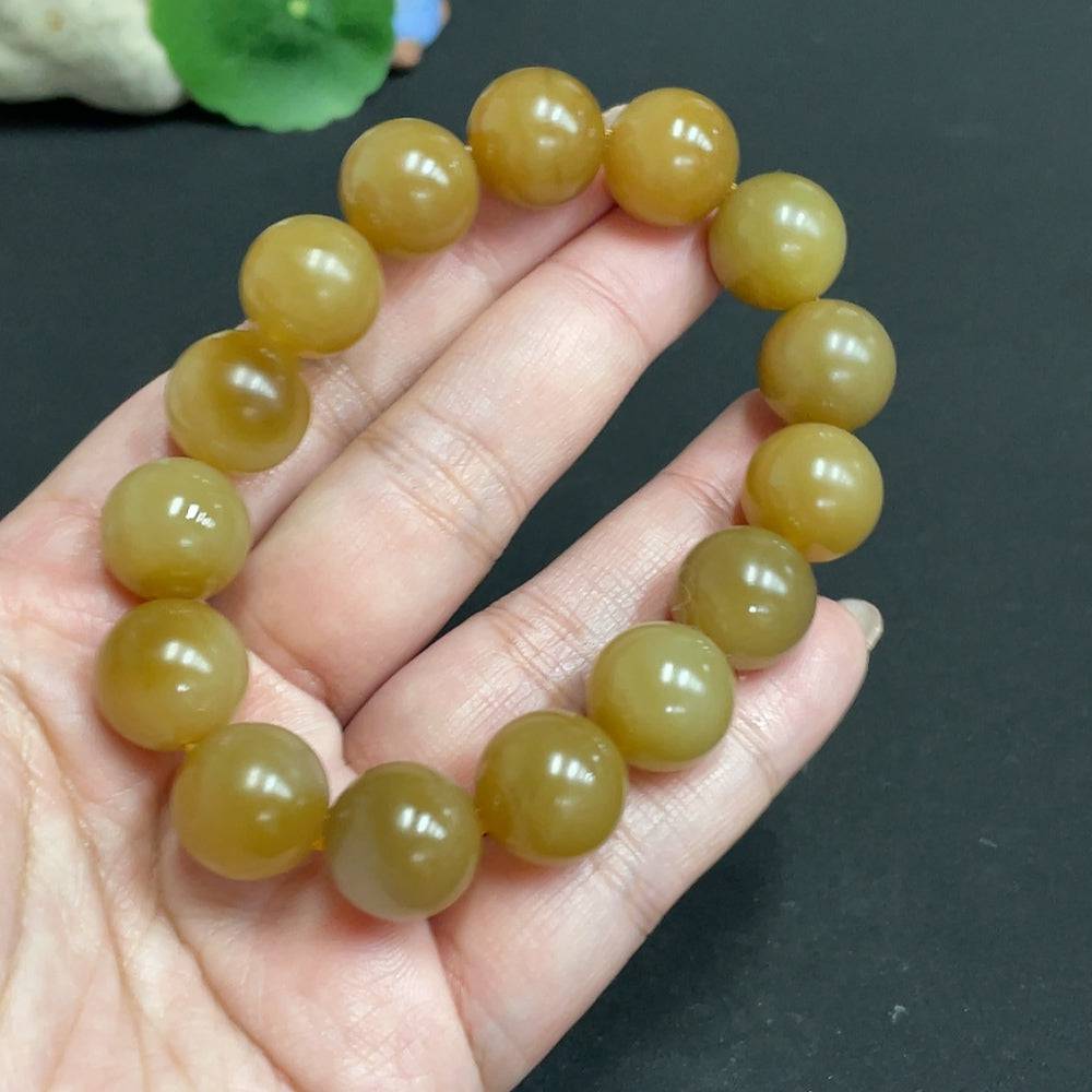 HUILIU HQ Hetian Jade bracelet with 13.9mm beads, showcasing smooth, polished green jade stones on a flexible band.
