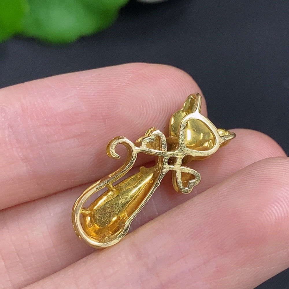 Jadeite pendant in 18K gold with diamond accents, elegant necklace showcasing a polished green jadeite stone and shimmering gold.