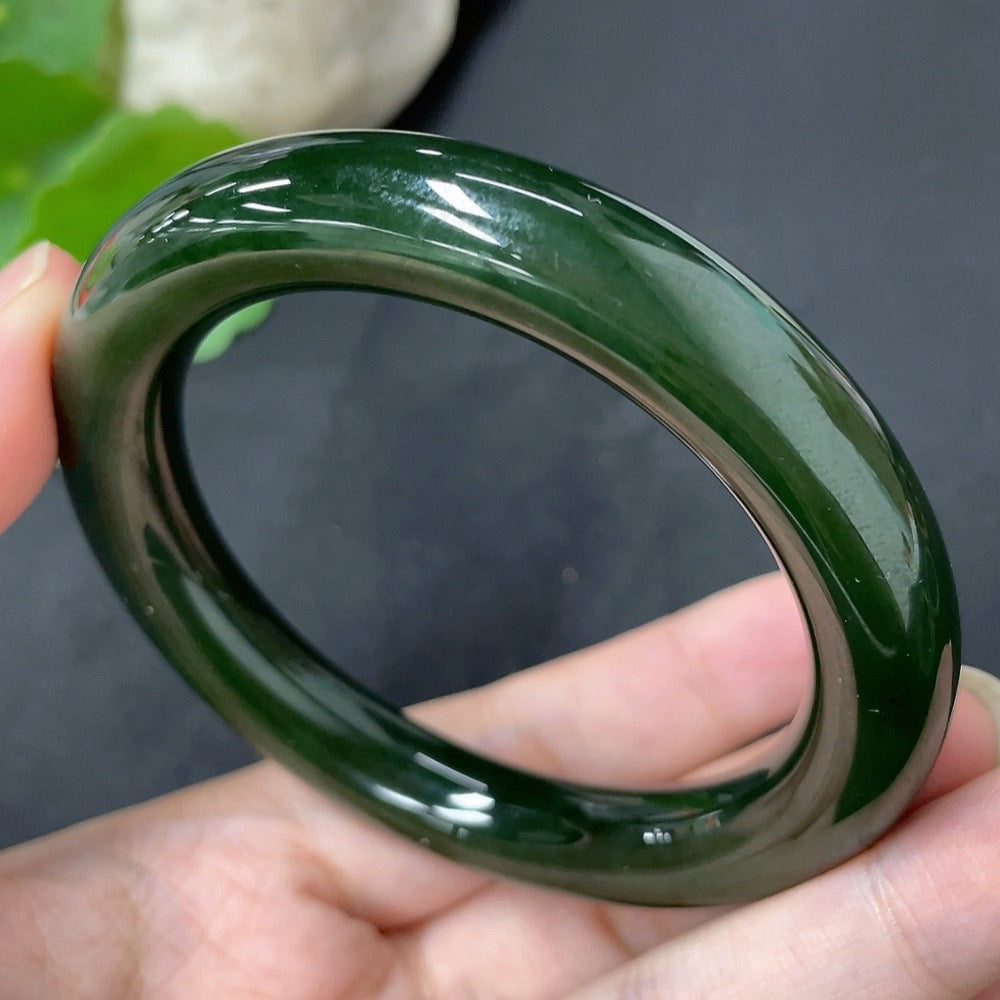 Green Hetian Jade round bangle with smooth surface, HKHQ brand, size 56.7 and weight approximately 58.8g, displayed on a neutral background.
